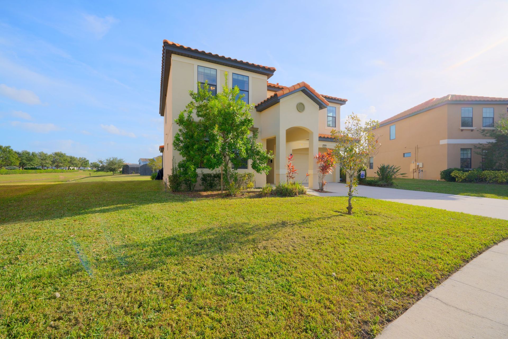 A large house with a lot of grass in front of it.