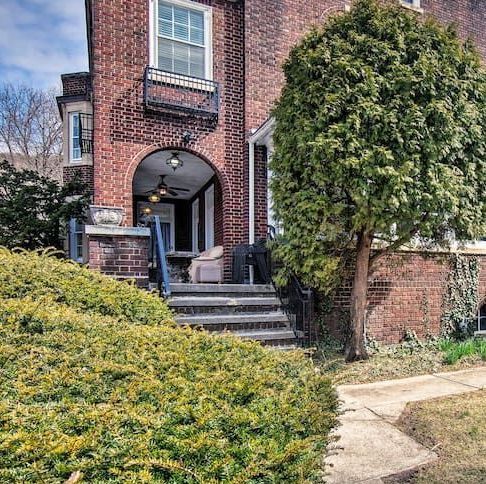 A brick house with a tree in front of it