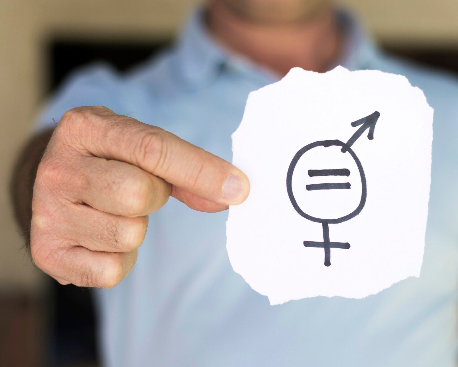Person holding paper with gender equality symbol. Equal Pay Litigation in Nashville Tennessee