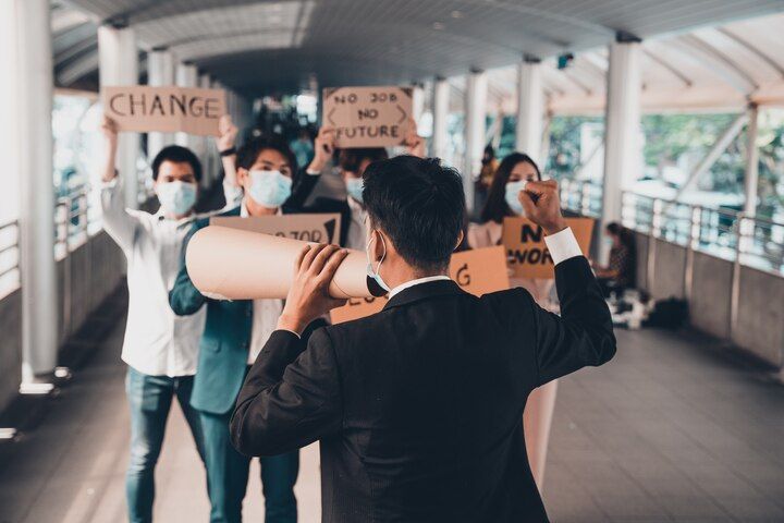 People protesting with signs, one using a megaphone in an urban setting. Public Order / Obstruction in Nashville, Tennessee