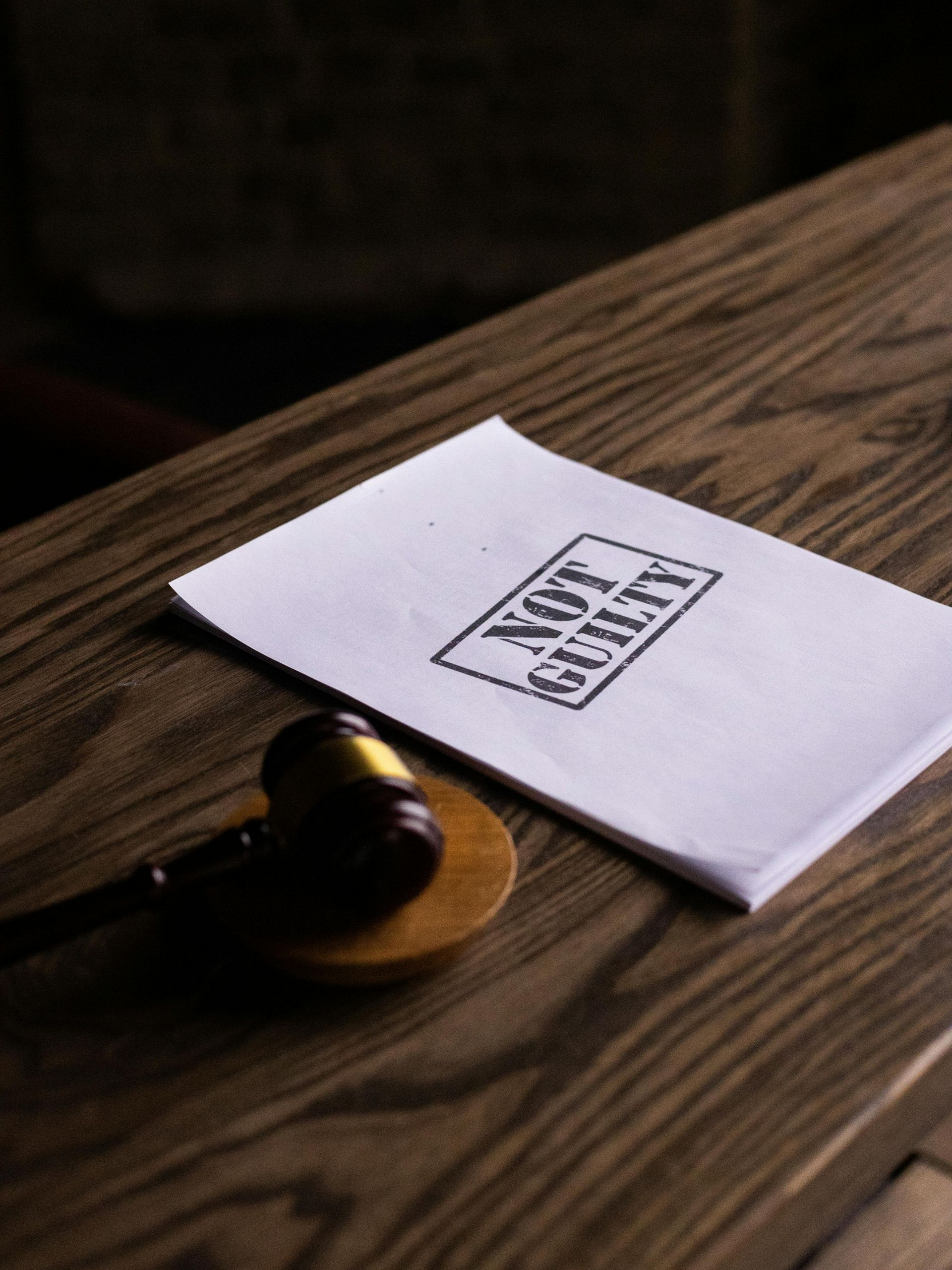 Gavel on stand next to a paper stamped 