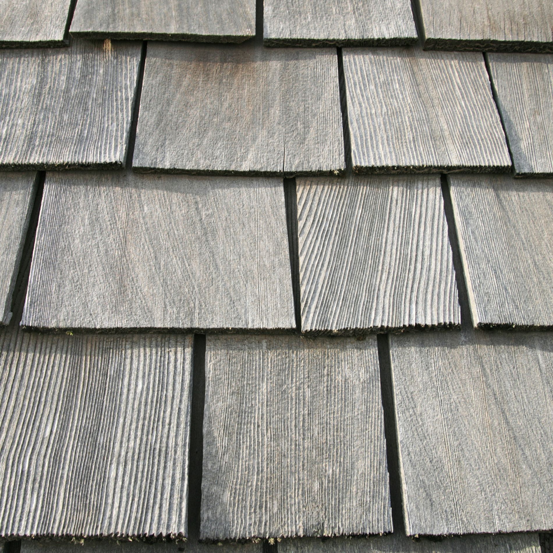 Gray wooden roof shingles close up.