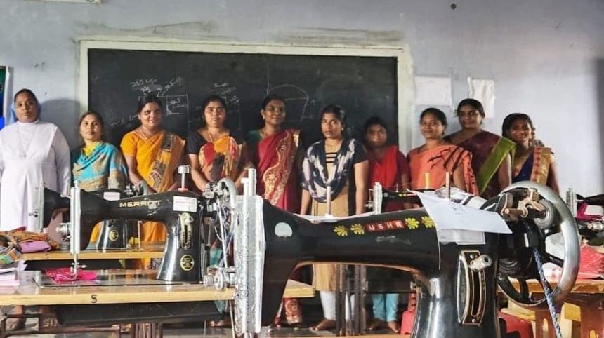 A group of women are standing in front of sewing machines.