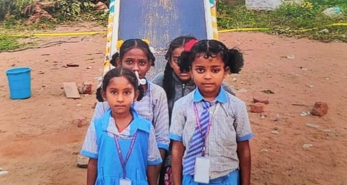 A group of young girls in school uniforms and ties are posing for a picture.