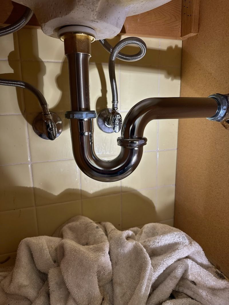 A bathroom sink with a towel underneath it.