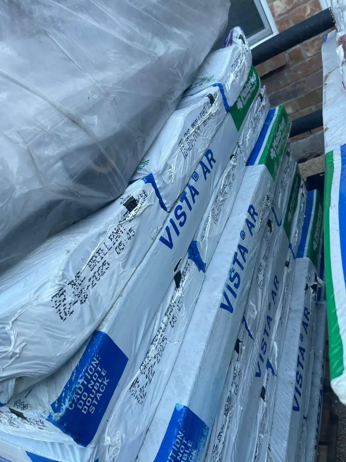 Stack of Vista AR roofing materials wrapped in plastic.