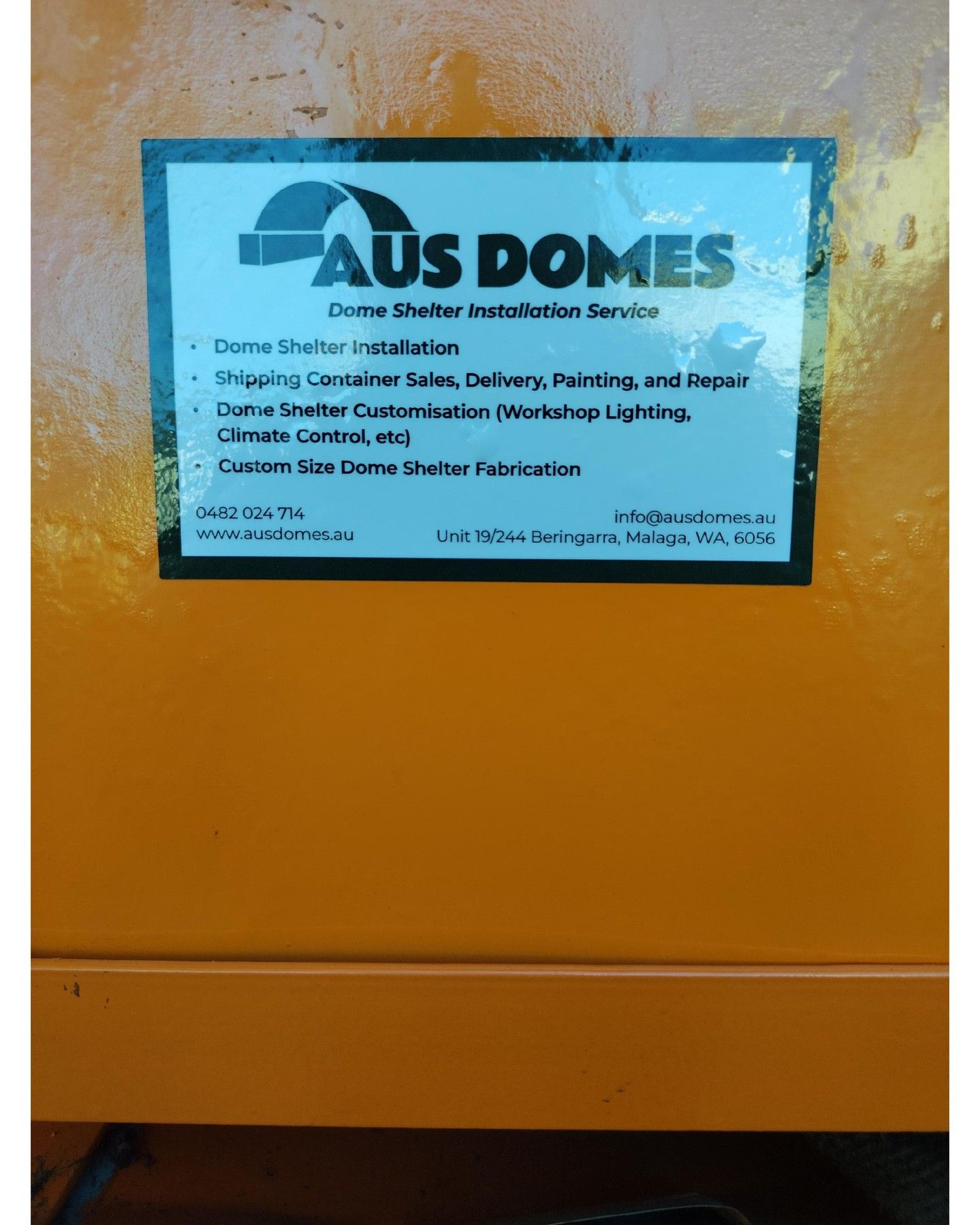 Orange surface with Aus Domes label providing dome shelter installation services.