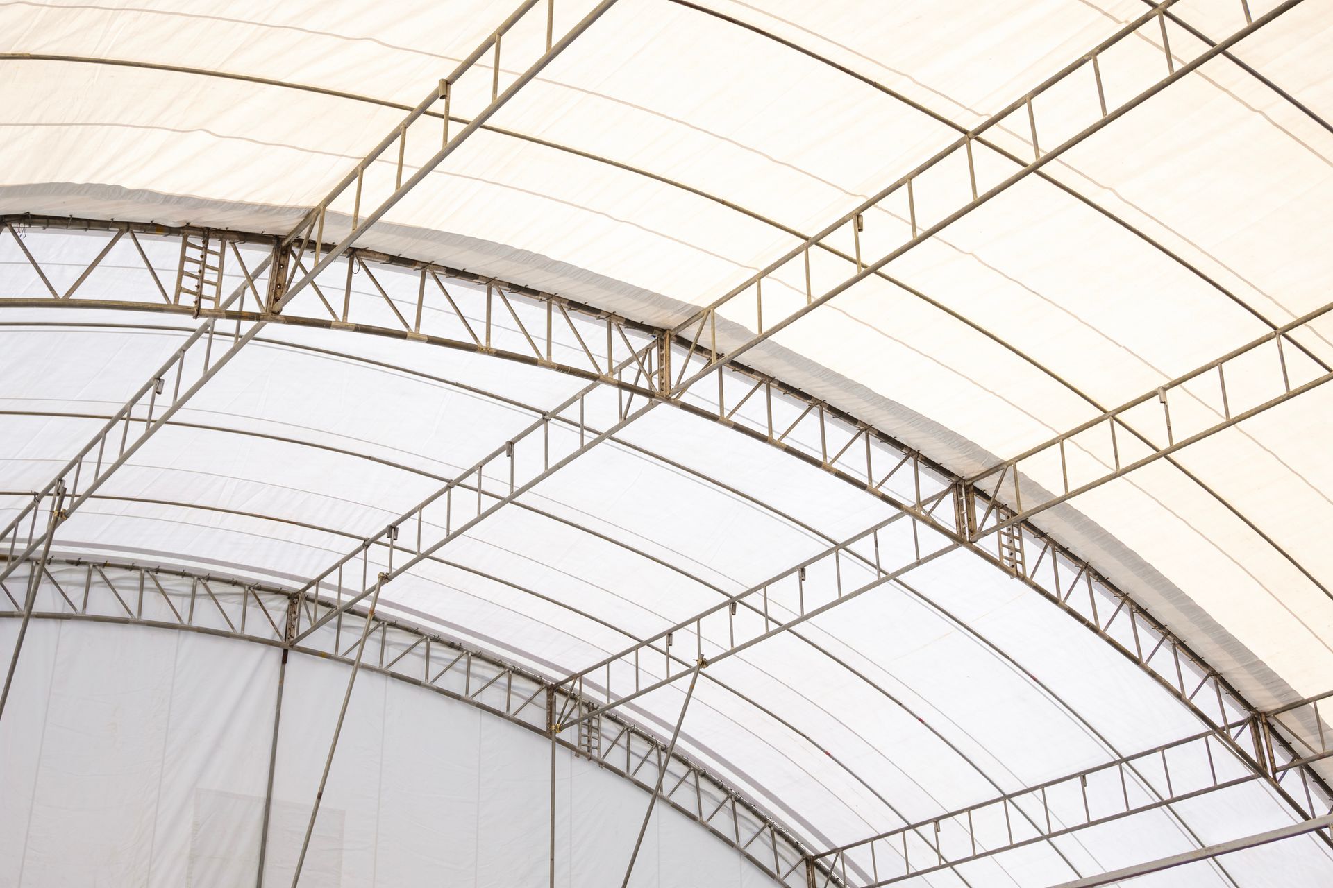 White canopy roof with metal frame, arching design.