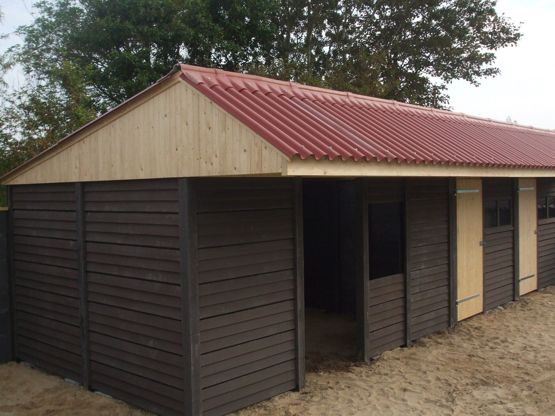 Loods met betonnen onderbouw en houten gevelbekleding, gerealiseerd door A&B Betonbouw.