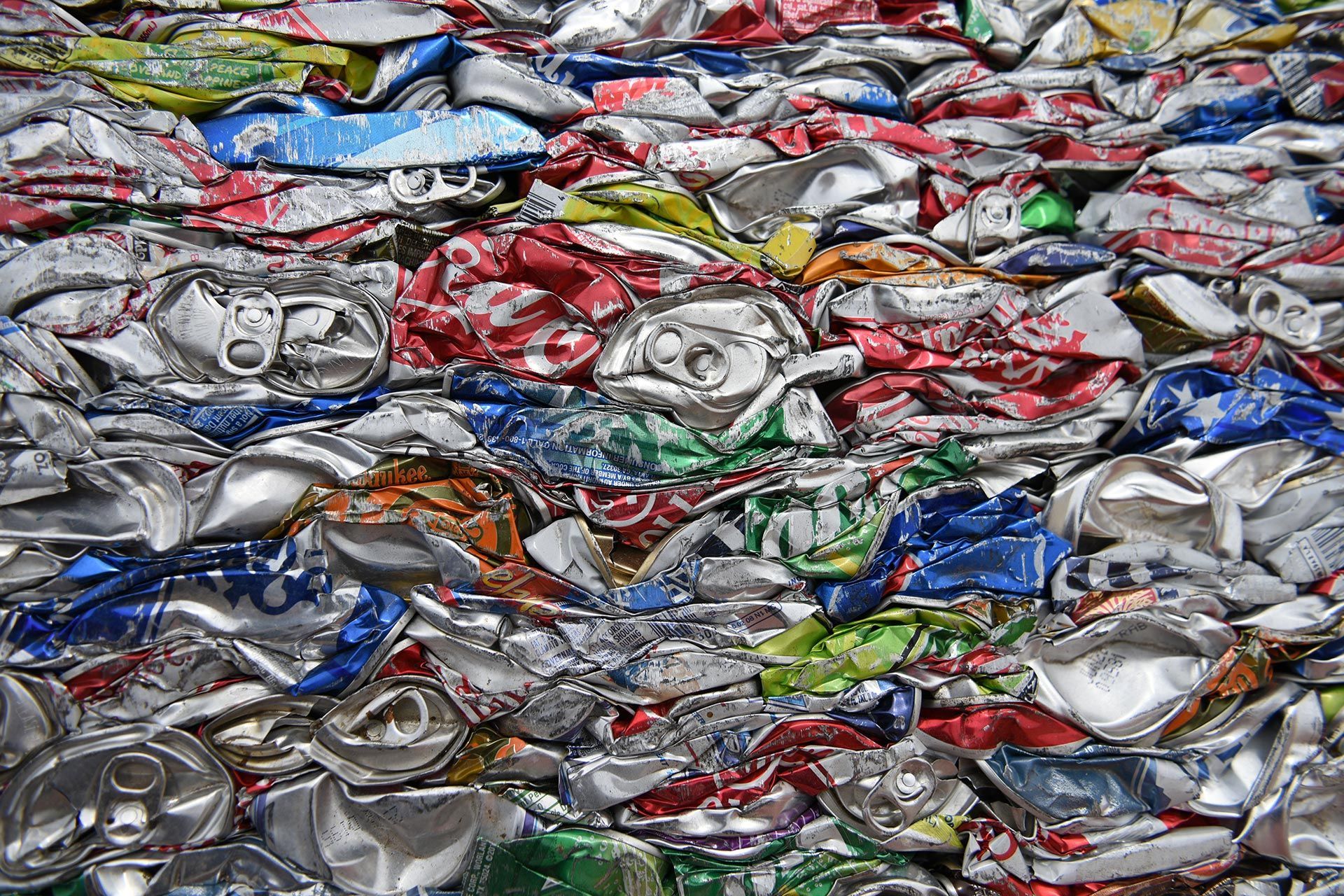 Crushed aluminum cans stacked for scrap metal recycling.