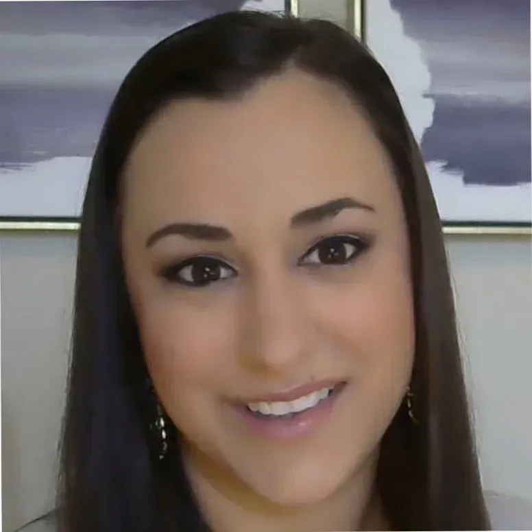 A close up of a woman 's face with a picture in the background