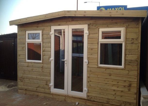 A wooden garden building with uPVC patio doors and windows