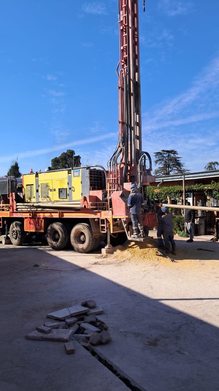 A truck is being used to drill a hole in the ground.