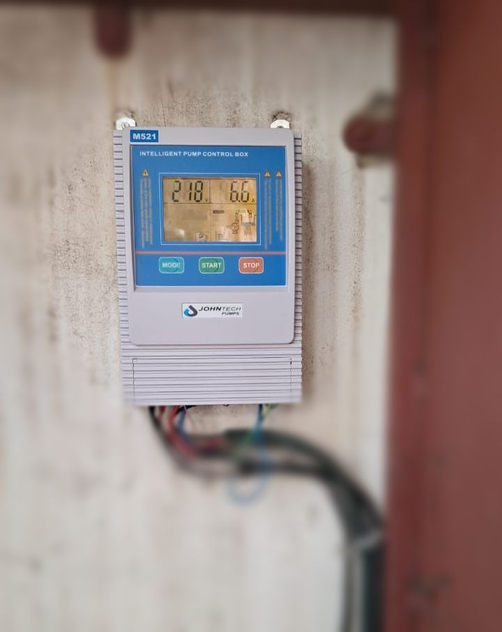 Electrical boards mounted to a wall in a room