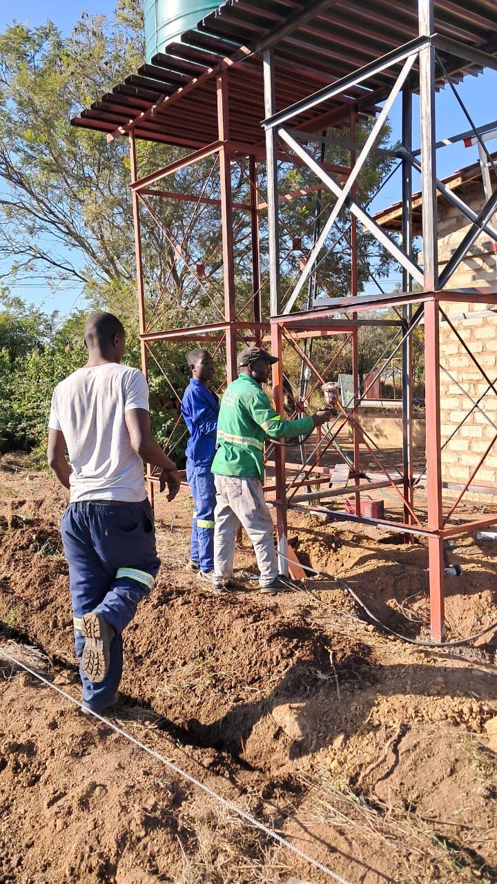 A drill bit is being used to drill a hole in the ground.