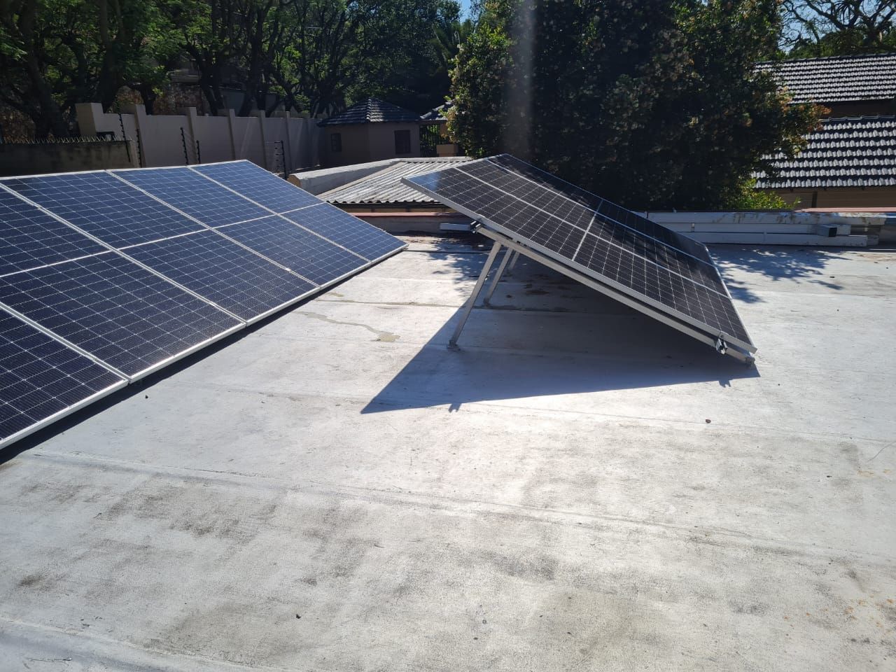 Two solar panels are on the roof of a house