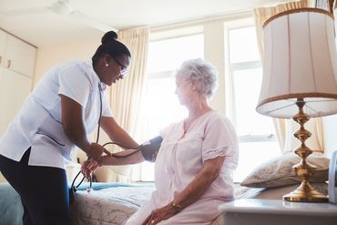 Senior Care — Nurse Checking Blood Pressure of Female Patient in Richmond, VA