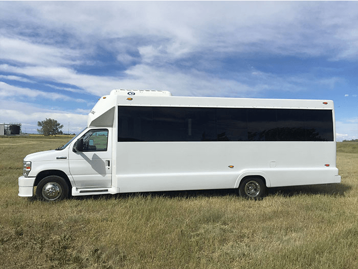 white E450 20 passenger party bus exterior side view