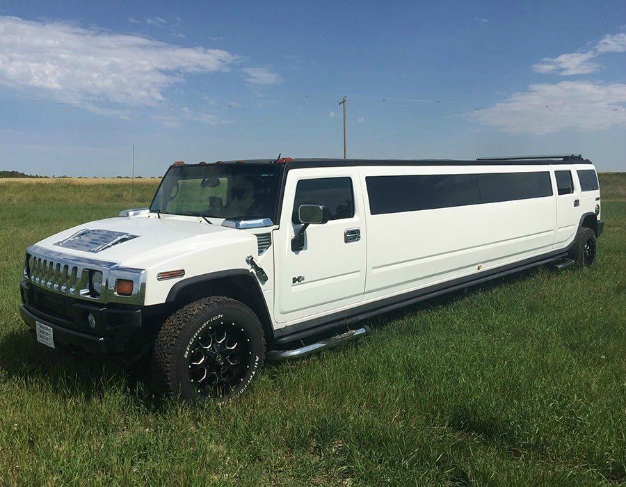 white H2 Hummer stretch SUV limousine exterior angled view
