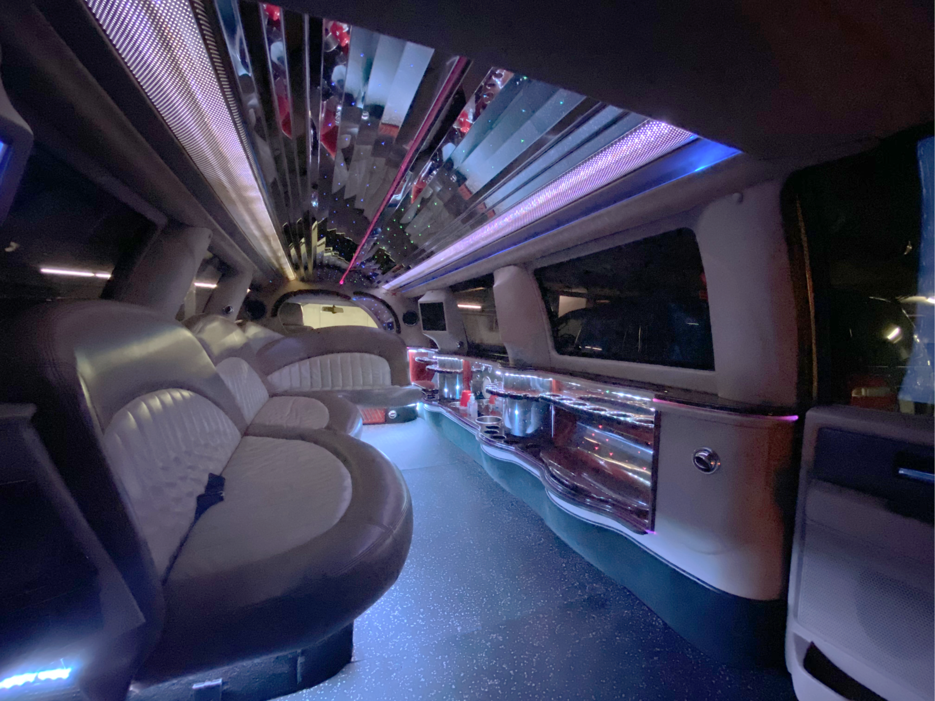 stretch limousine interior with LED lighting and side bar area