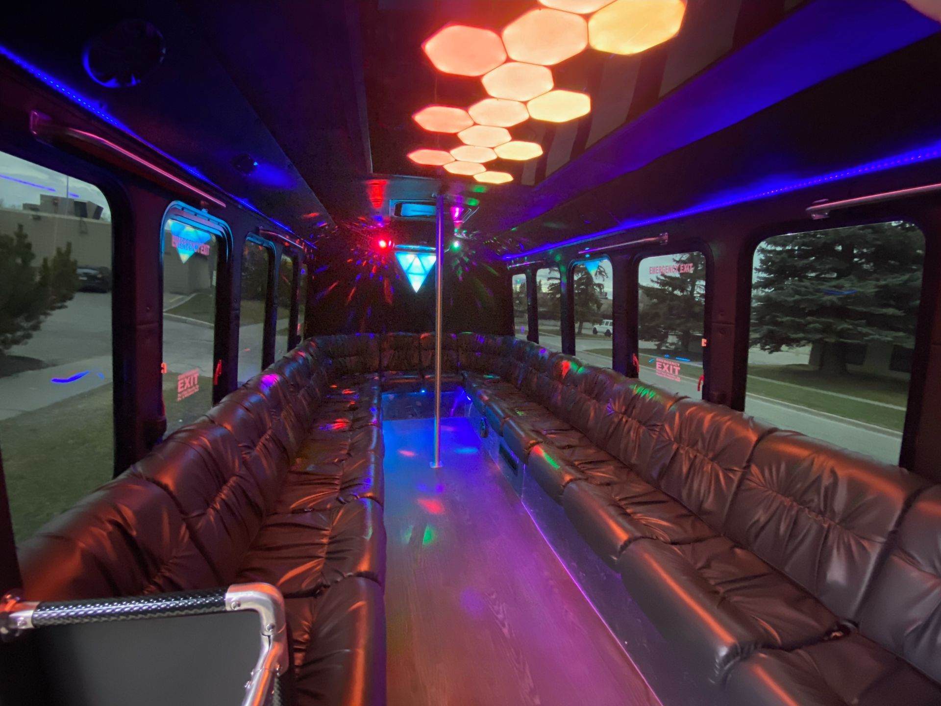 Ford Transit Battisti Limo To Go 12 Passenger black party bus interior rear facing view with wraparound seating and LED lighting