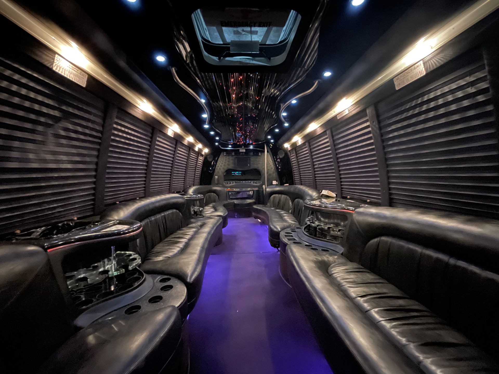Limo To Go Krystal Coach 24 passenger white party bus interior elegant curved custom seating with underglow and overhead LED starlights