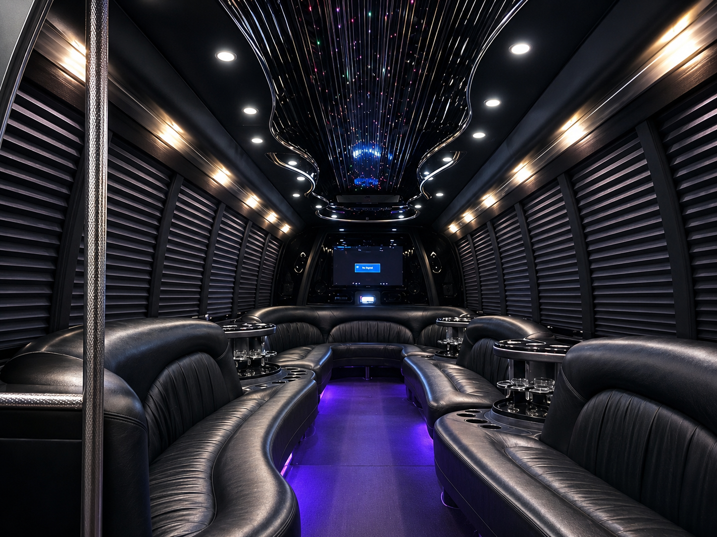 Luxurious black party bus interior with purple floor lighting and LED ceiling lights