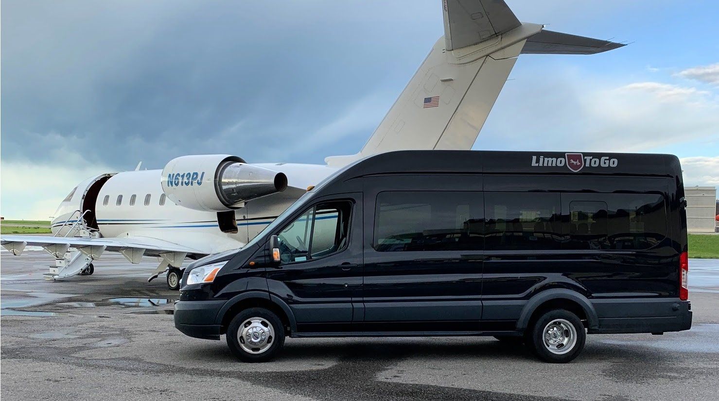 stretch limousine parked on runway beside private jet with lowered stairs