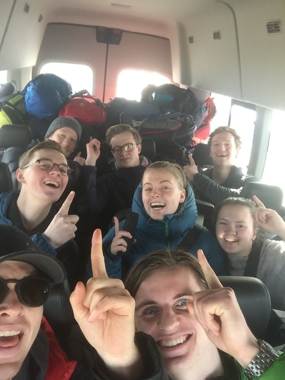 a group of people are posing for a picture in a van