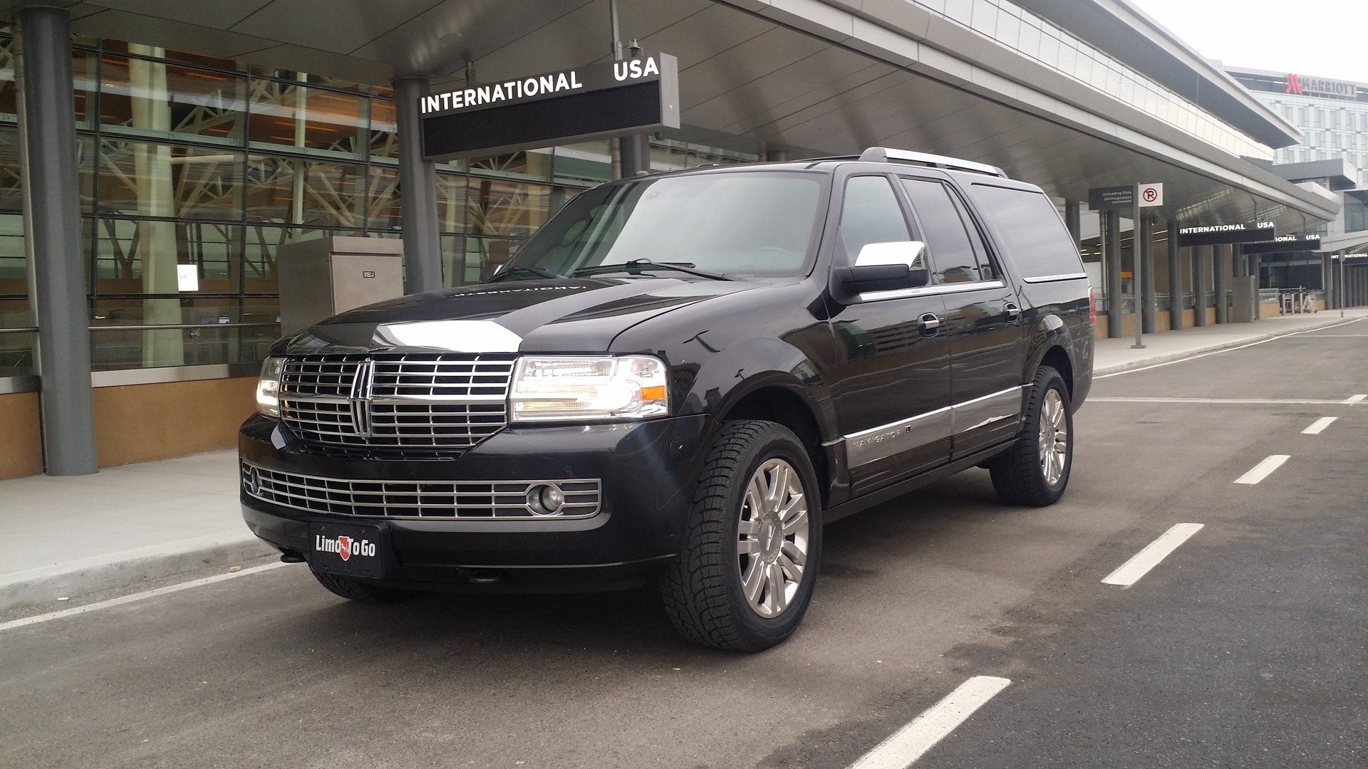 black Limo To Go Lincoln Navigator L full size SUV parked at Calgary Airport