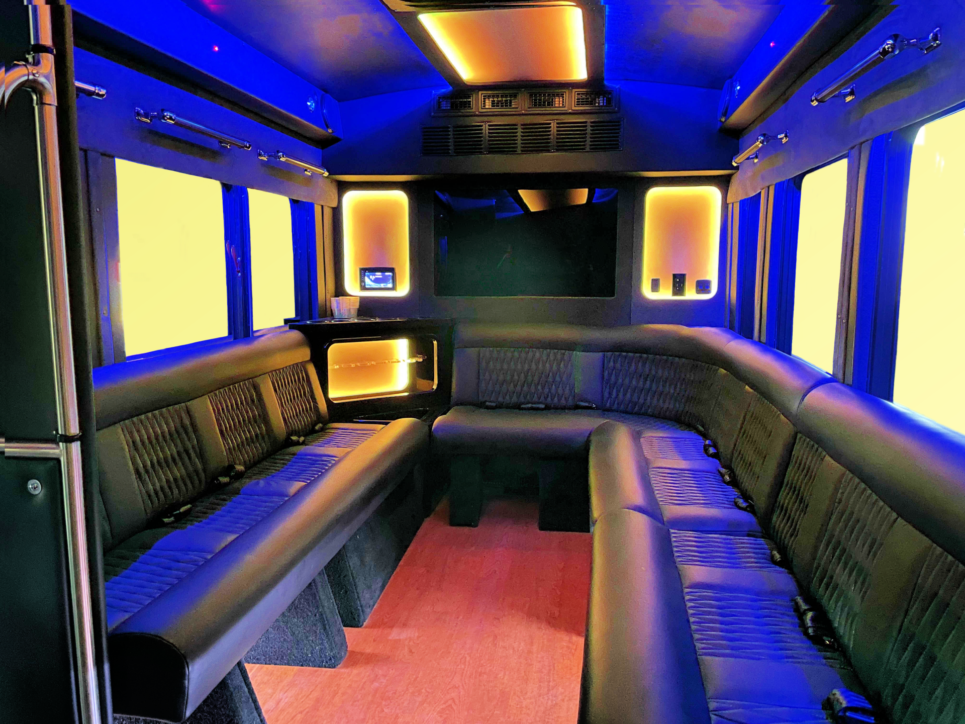 the inside of Battisti party bus with gold LED lights on the ceiling