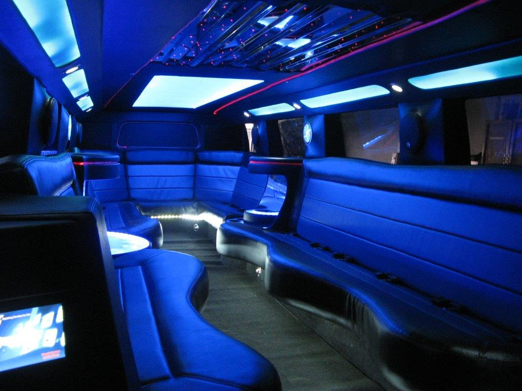blue lit interior of white H2 Hummer stretch limousine