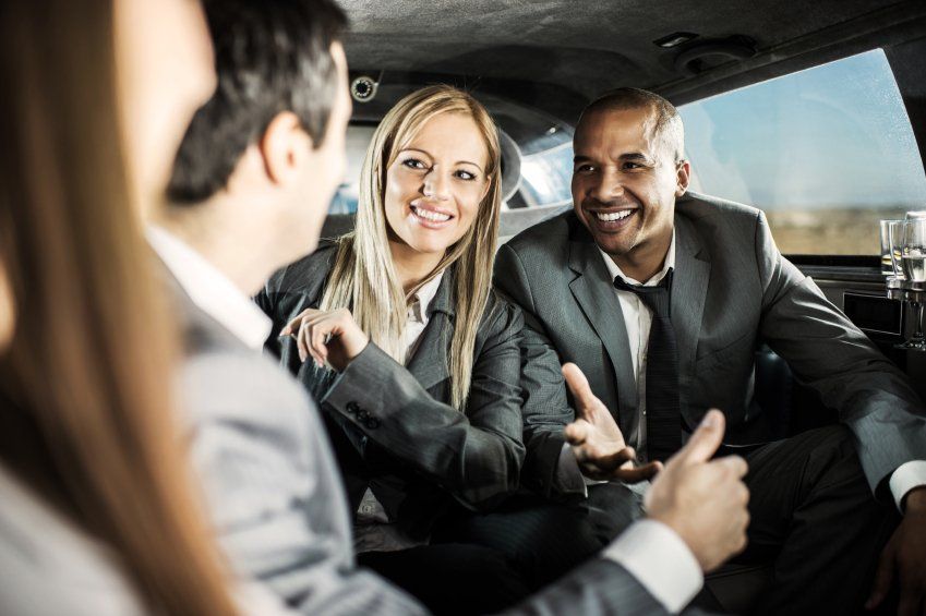coworkers riding in limo to meeting