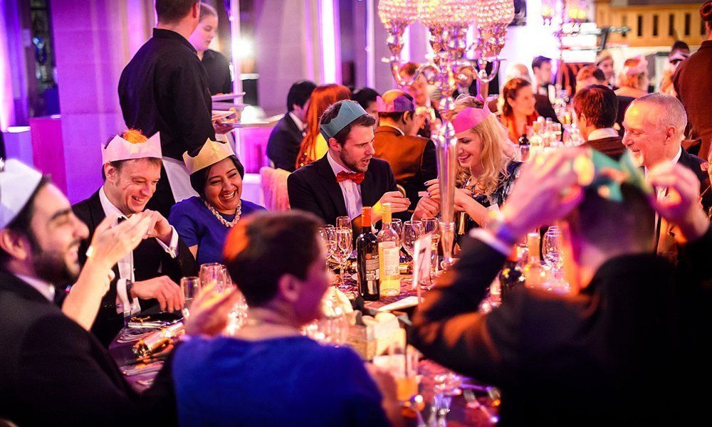 office coworkers seated at Christmas party table