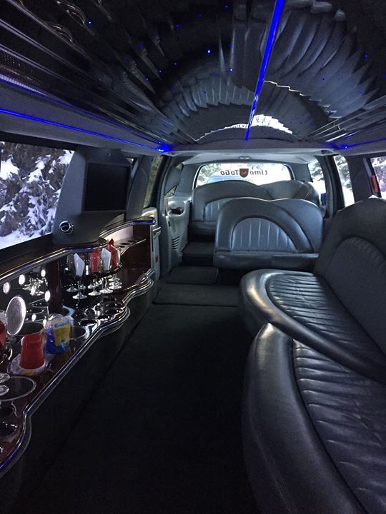 the inside of a limousine with lots of seats and a bar .