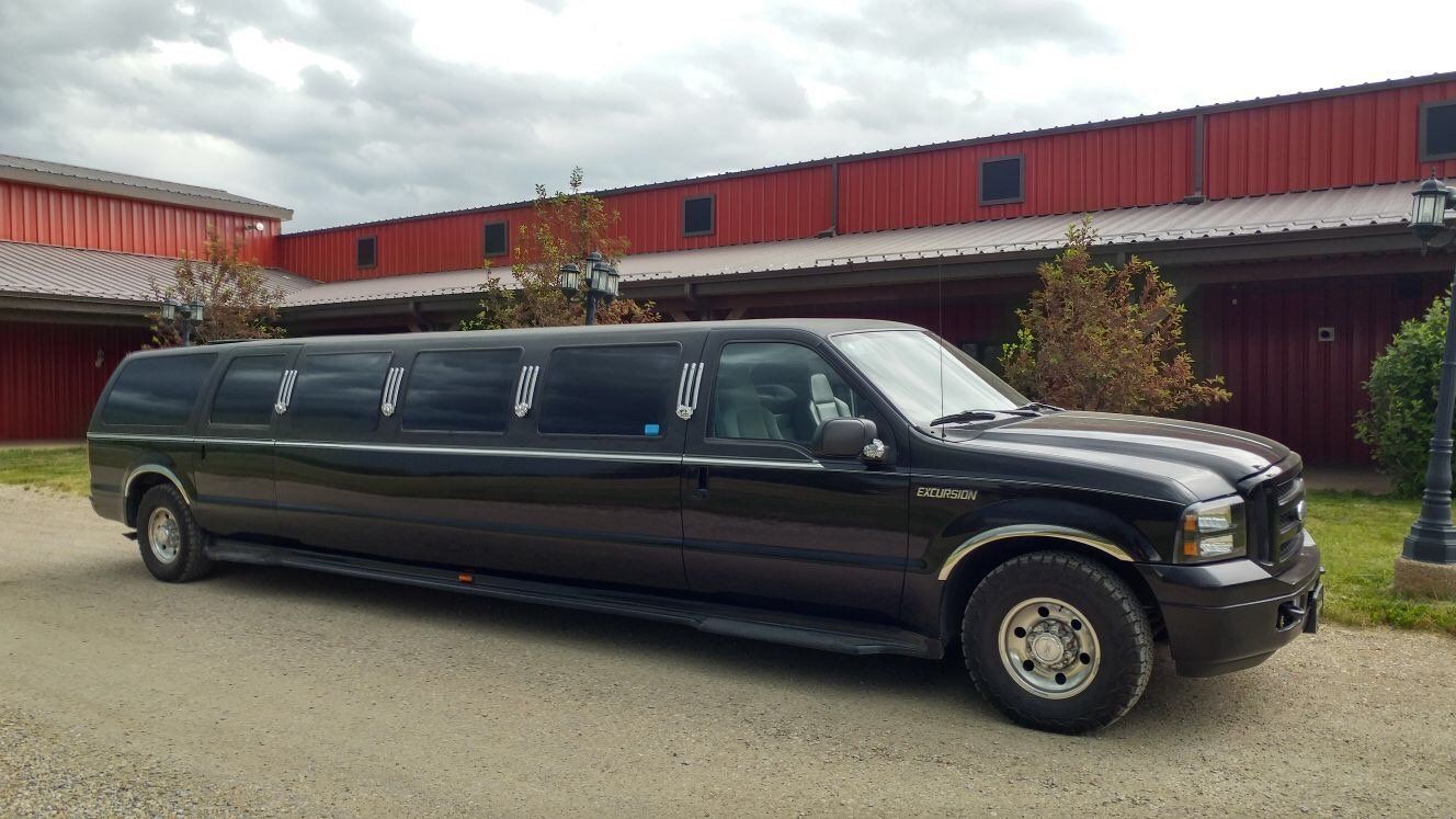 black Excursion stretch SUV limousine parked at wedding venue