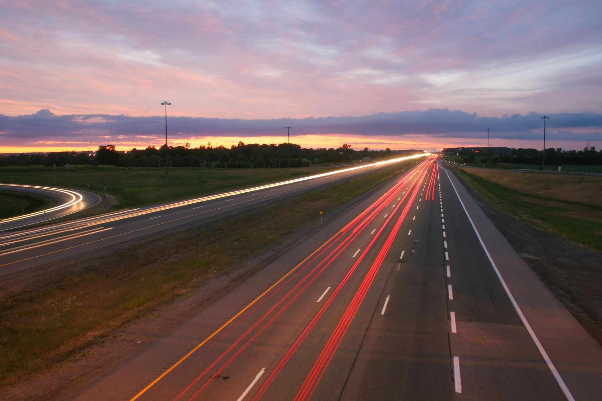 A highway with a sunset in the background