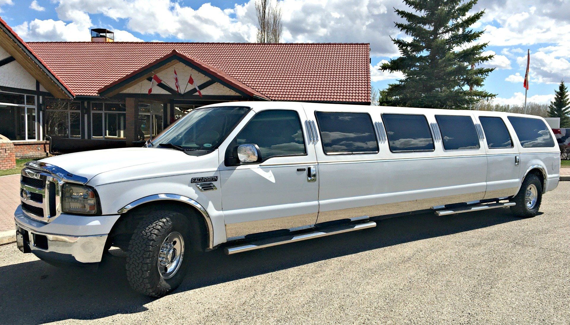 a white limousine is parked in front of a house .