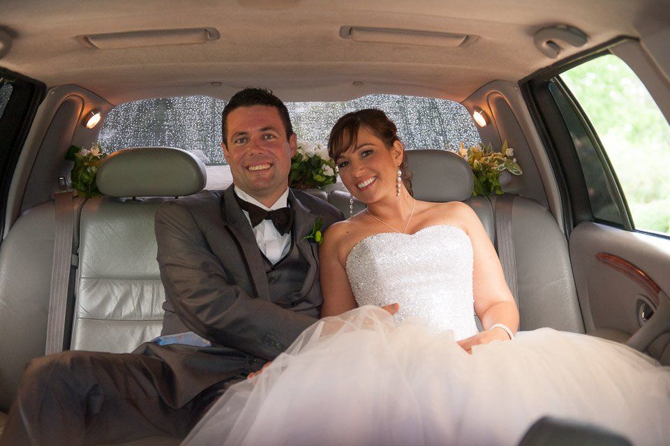 white Limo To Go stretch limo with just married sign on back