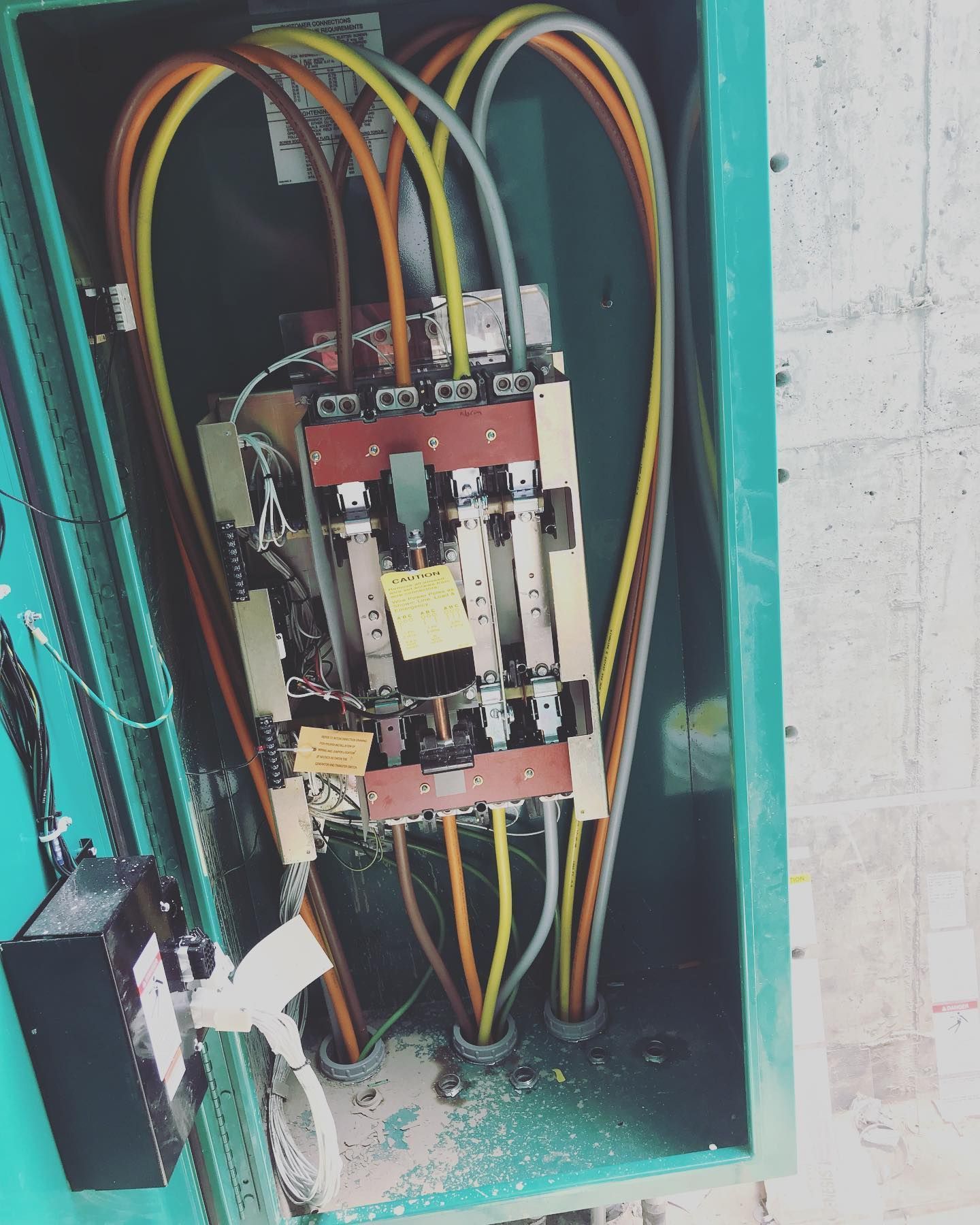 A green box with a bunch of wires coming out of it