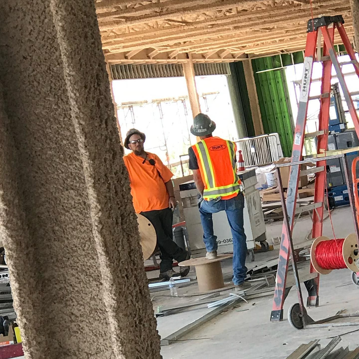 A group of construction workers are working on a building under construction.