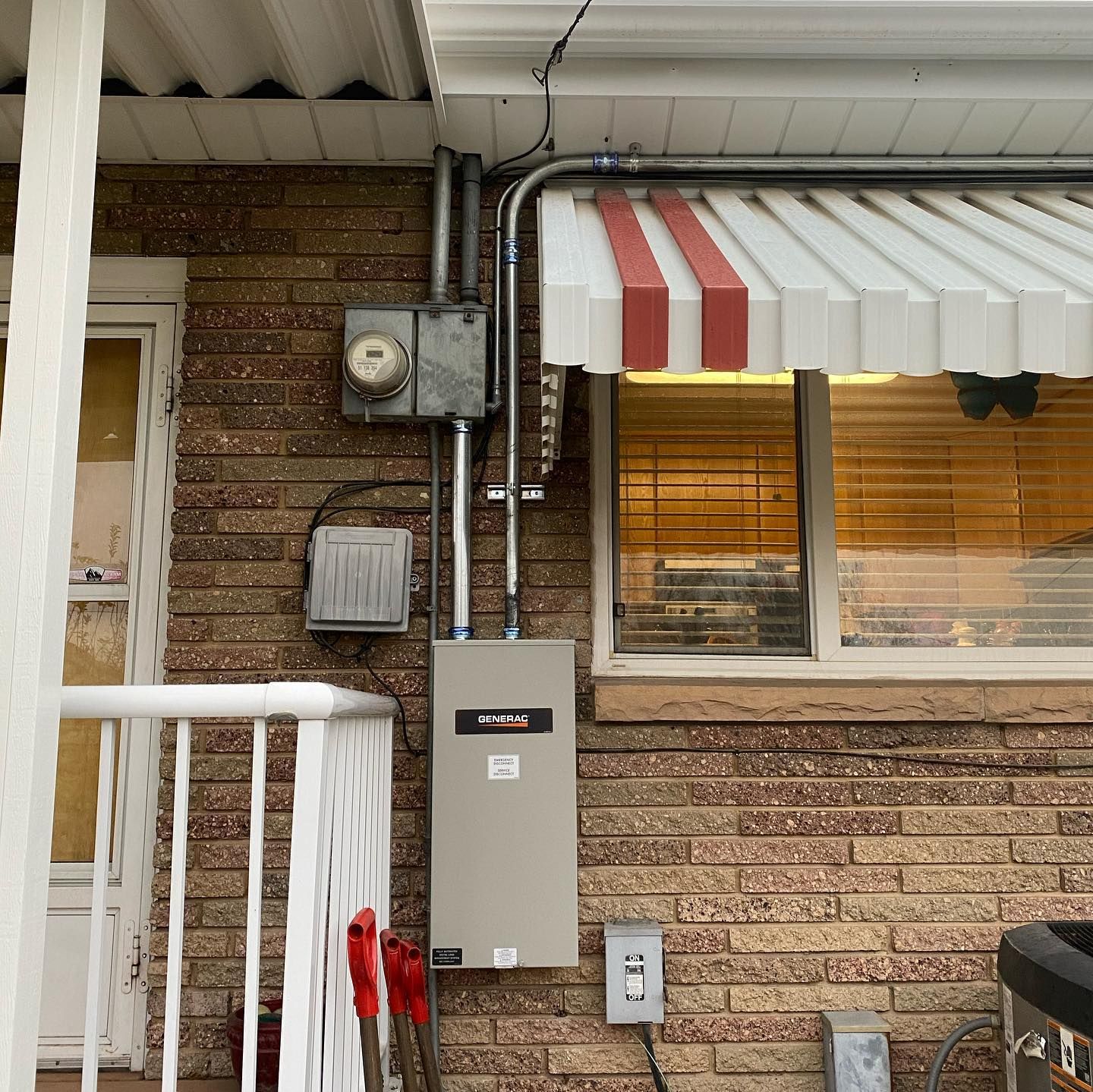 A brick building with a white awning over a window