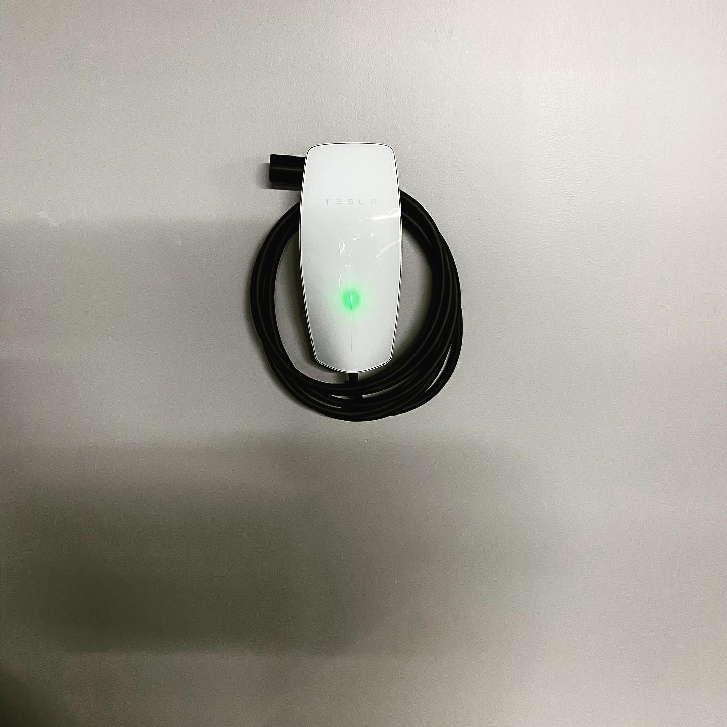 A white device with a green light on it