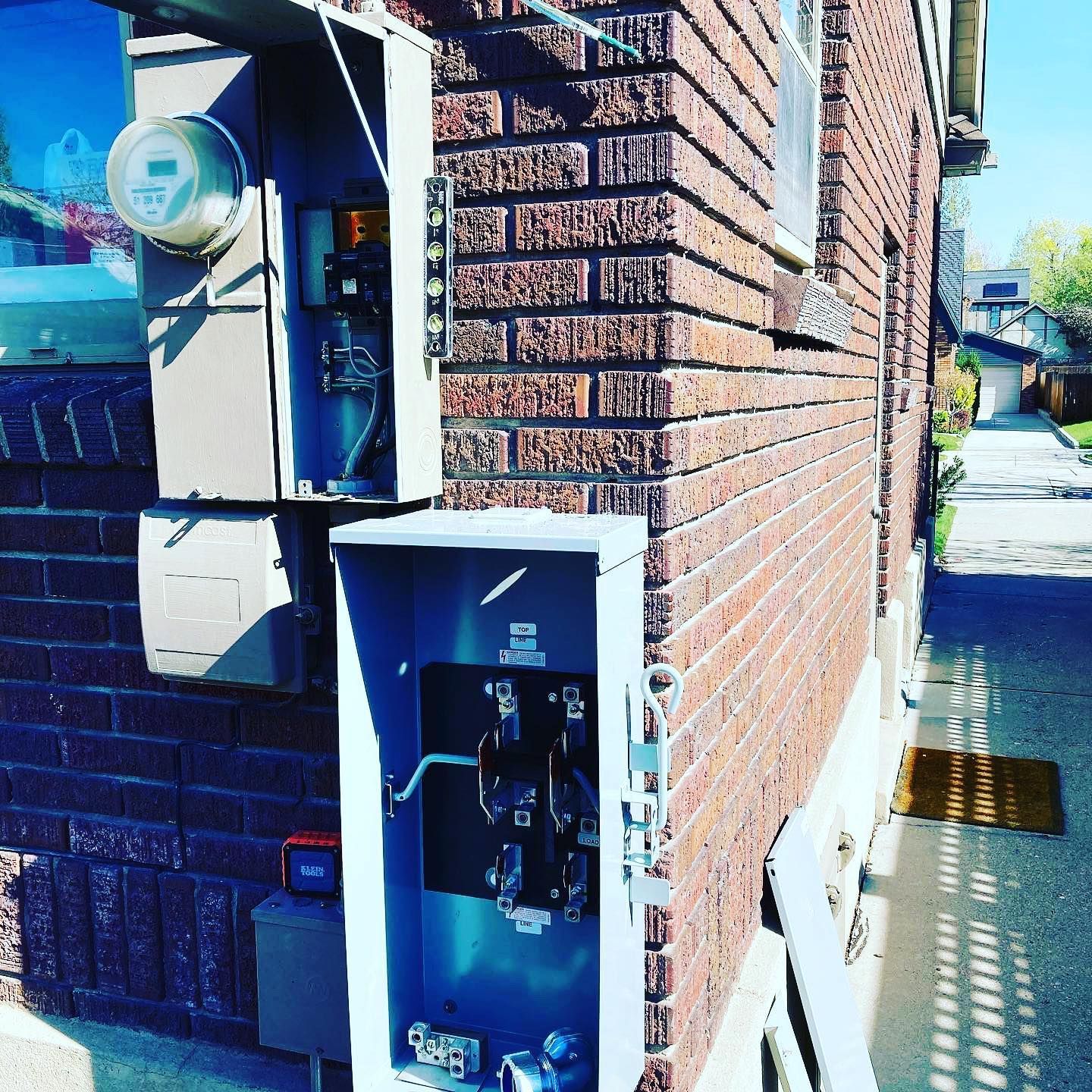 A brick building with a meter on the side of it