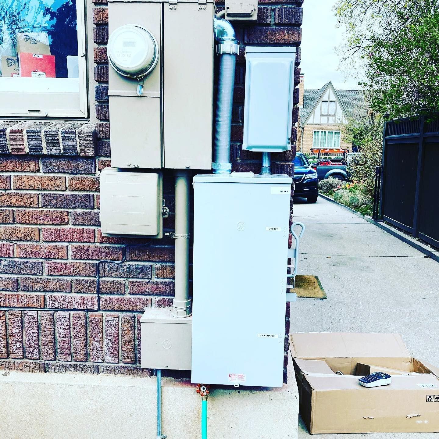 A brick building with a box on the sidewalk in front of it