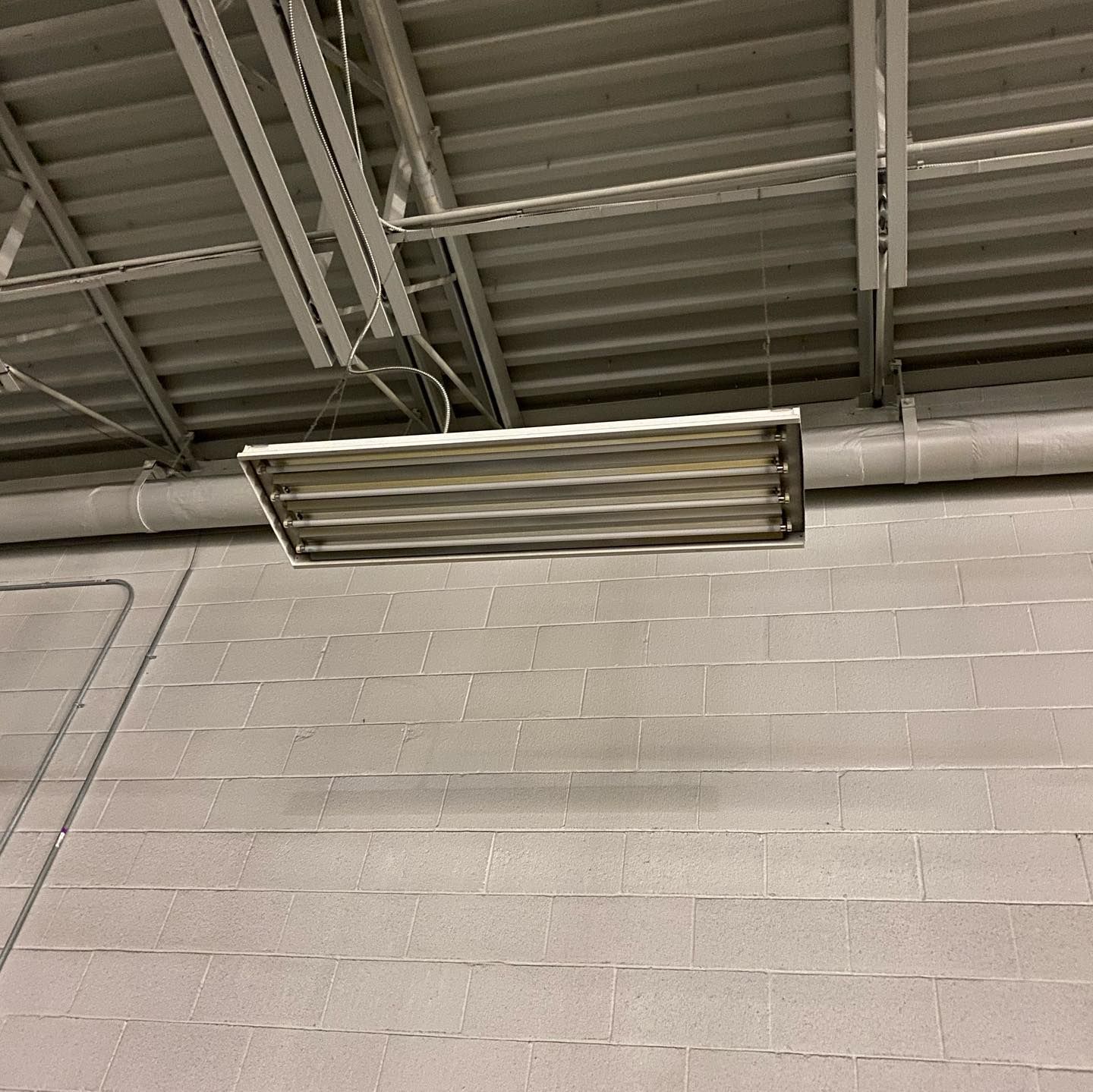 A light fixture is hanging from the ceiling of a building.