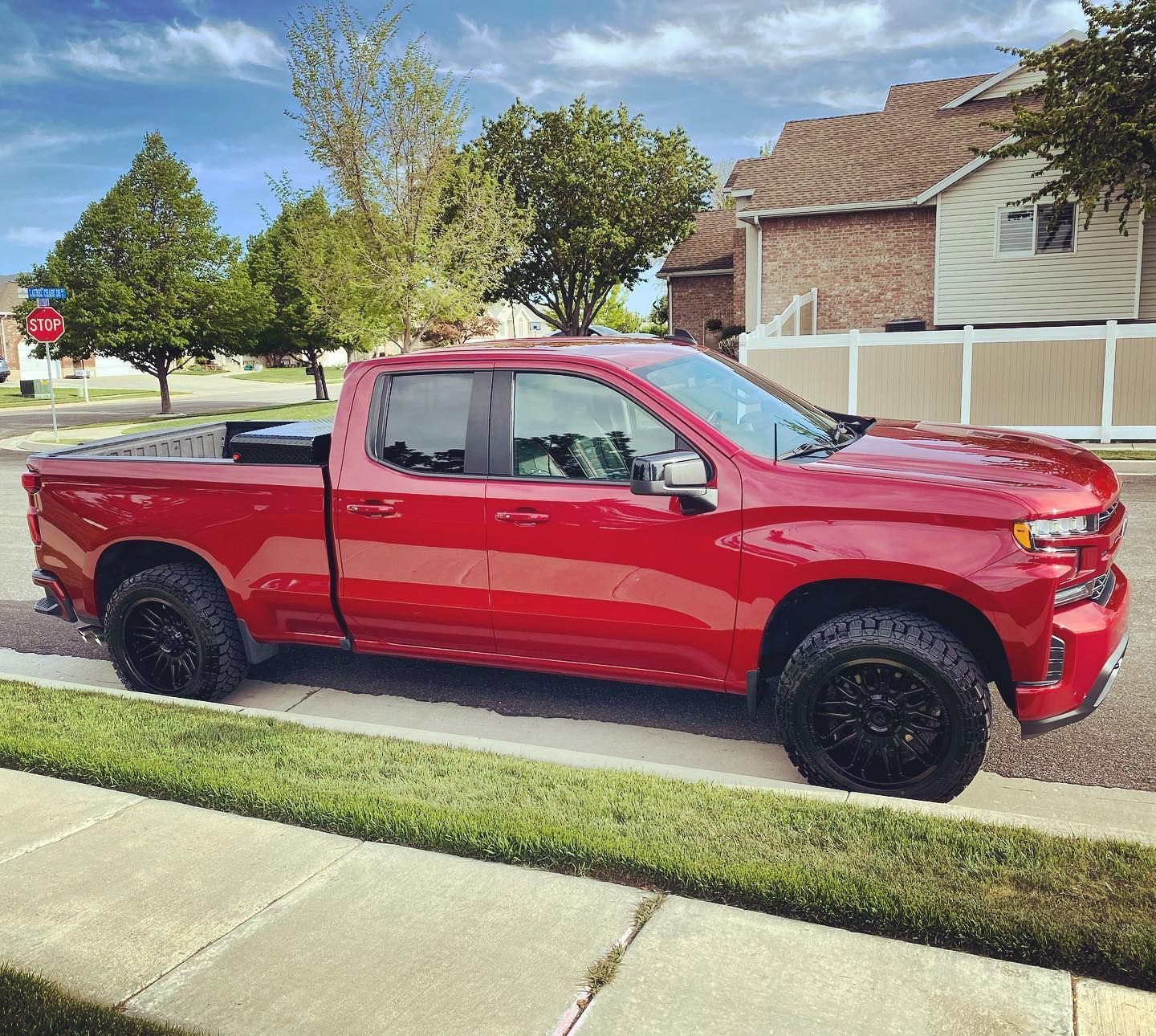 A red truck is parked on the side of the road.