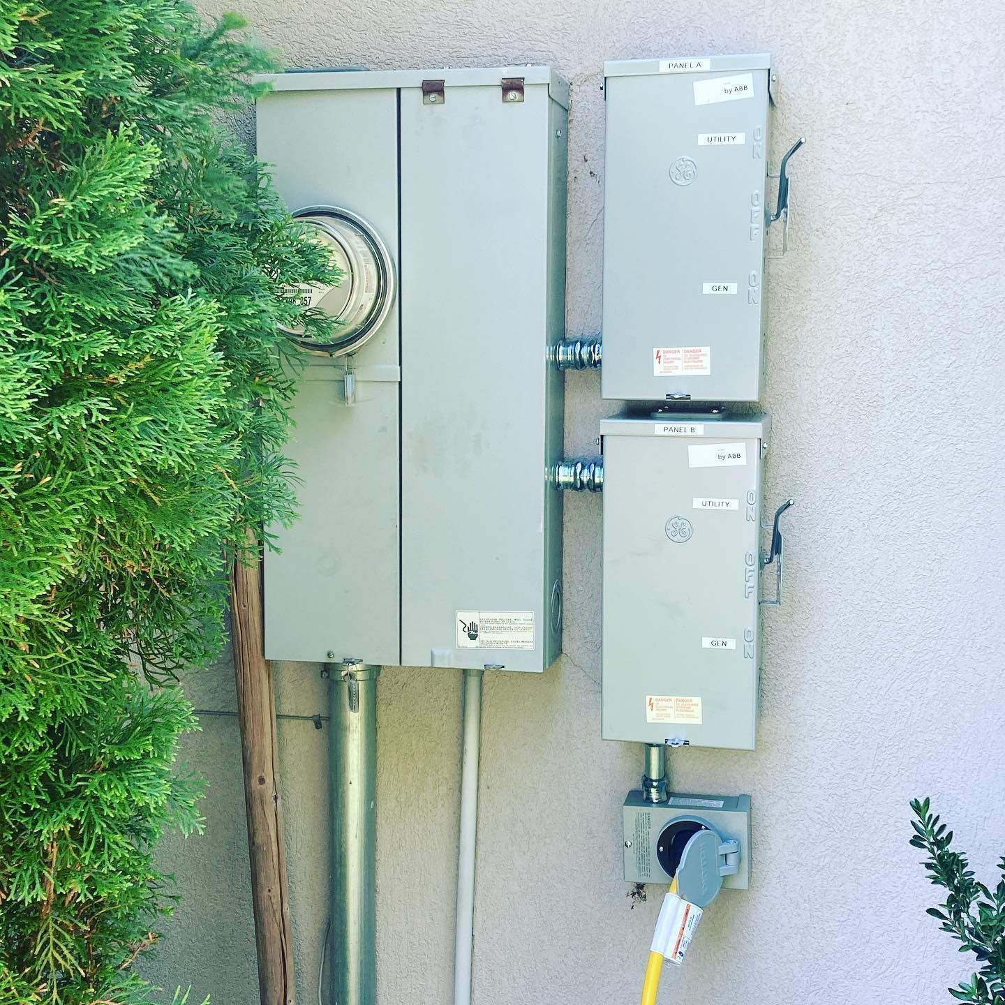 A couple of electrical boxes on the side of a building