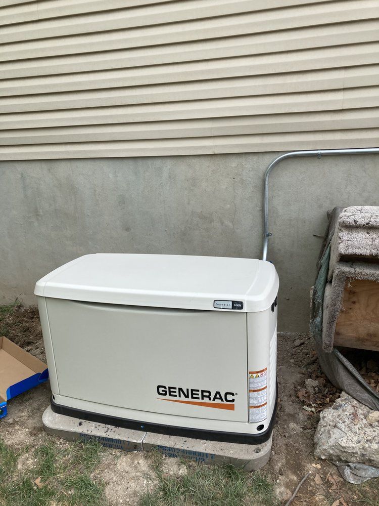 A generator is sitting in front of a house.