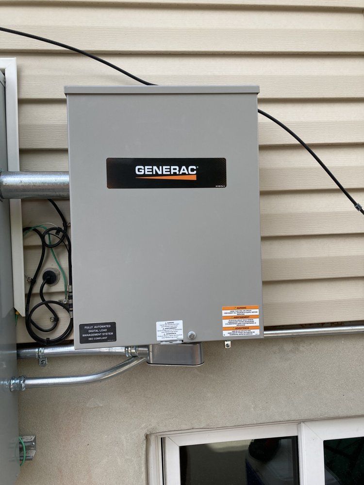 A generator is mounted on the side of a house.